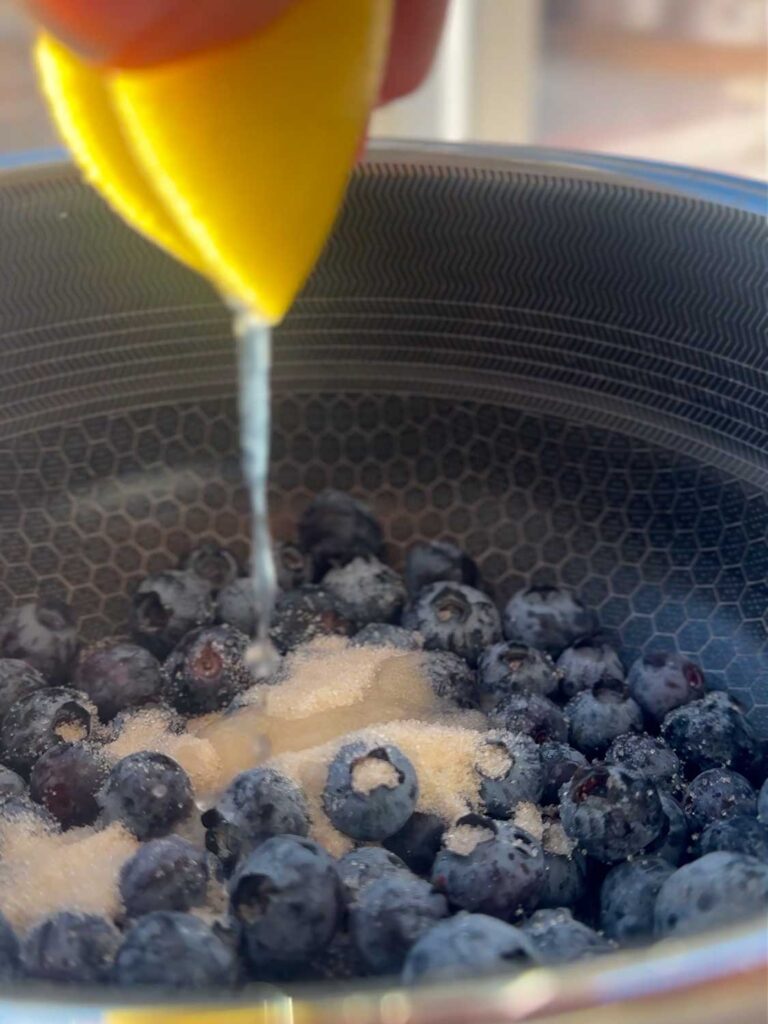 adding lemon juice for blueberry sauce